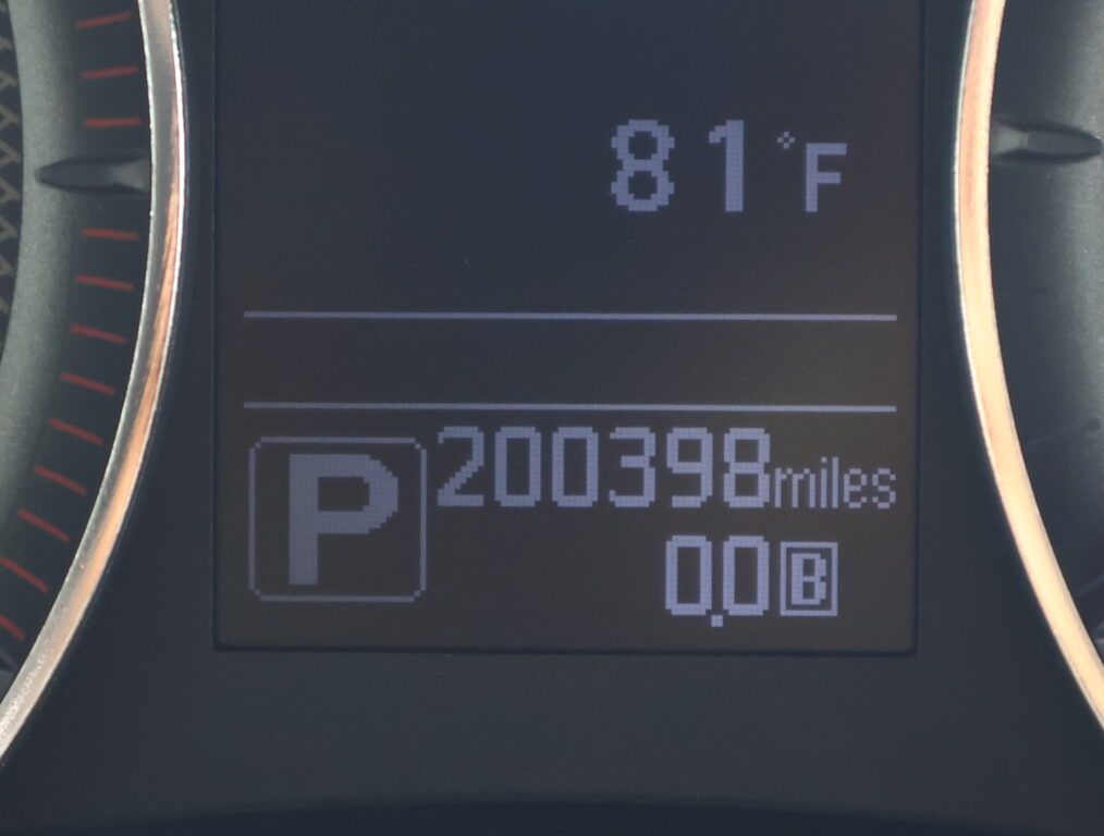 Car dashboard showing outside temp 81°F, parking indicator 'P', and odometer reading 200,398 miles.