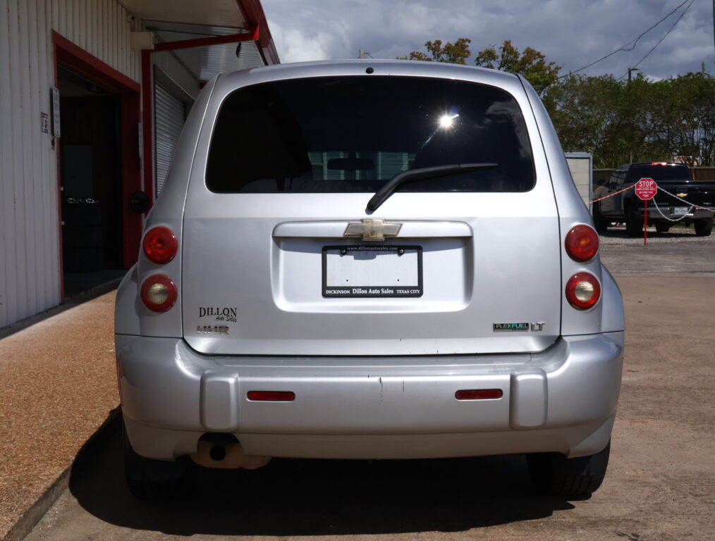 Rear view of a silver Chevrolet SUV parked at a car dealership, with a Dillon Auto Sales plate frame visible on the bumper.