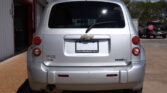 Rear view of a silver Chevrolet SUV parked at a car dealership, with a Dillon Auto Sales plate frame visible on the bumper.