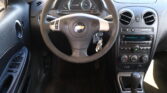 View of a car's interior focusing on the steering wheel, instrument cluster, and center console on the dashboard (Chevrolet).