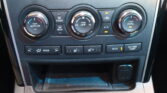 Car climate control panel with three knobs: left “Push Auto On,” center “Push Off/Lo–Hi,” right “Push Dual” for driver/passenger, plus A/C and defrost buttons above.