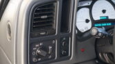 Close-up of the car dashboard on the driver’s side showing a rectangular air vent and climate control knobs nearby? careful: keep straightforward: Close-up of the driver’s side dashboard with a rectangular air vent and control knobs nearby.