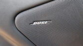 Close-up of a Bose car speaker grille embedded in a textured dashboard panel.