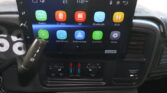 Car infotainment screen showing apps: Radio, U-disk, SD, Bluetooth, AUX; time 11:07 AM.