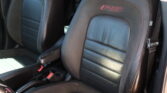 Black leather car seats with red stitching and an RS logo embroidered on the headrest area.