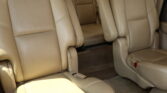 Beige leather car seats with captain's chairs and visible seat belts in a vehicle interior