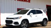 White Chevrolet SUV parked outside a white building with red trim and a bold 'We Finance' sign above.