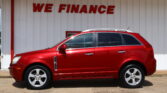 Red SUV parked in front of a white building with a bold red 'WE FINANCE' sign above the car.