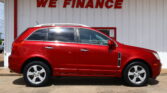 Red SUV parked in front of a white building with a bold 'WE FINANCE' sign above it, indicating a financing dealership.