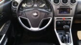 Interior view of a car dashboard featuring a round steering wheel with Chevrolet logo, instrument cluster, and center console with a touchscreen display and climate controls.
