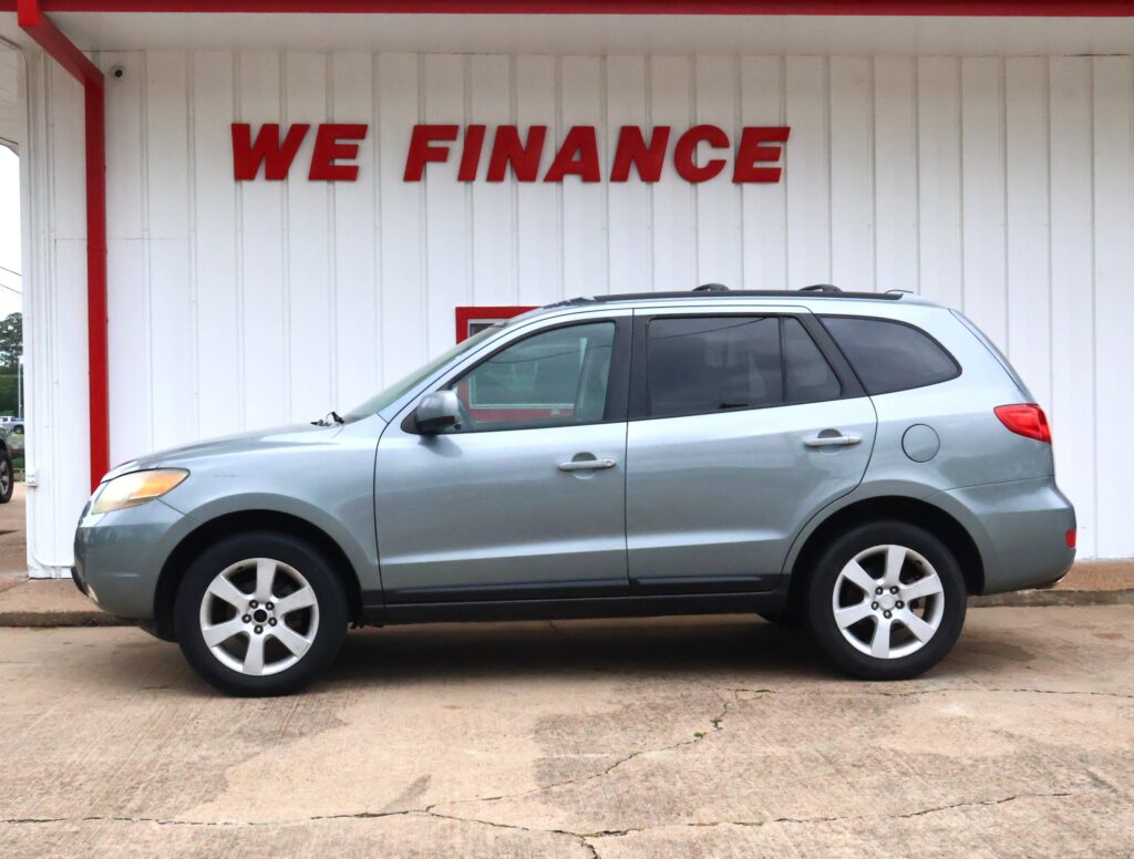 Silver SUV parked in front of a white wall with a red 'WE FINANCE' sign above it