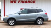 Silver SUV parked in front of a white wall with a red 'WE FINANCE' sign above it