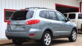 Silver Hyundai Santa Fe parked outside a finance office with white walls and red trim.