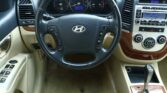 Front seat view of a car dashboard with steering wheel, speedometer, and center console.