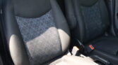 Front car seats with dark fabric upholstery and a geometric patterned center panels in gray and black tones.