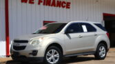 White SUV parked in front of a white wall with red trim and a bold 'WE FINANCE' sign above it.