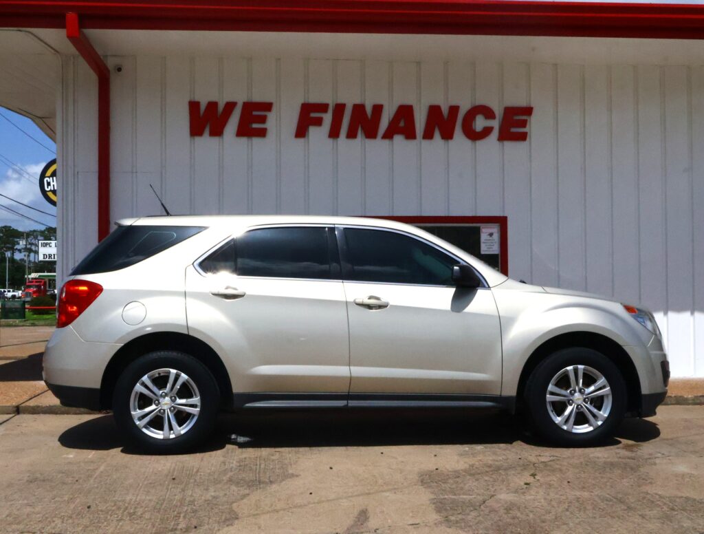 White SUV parked in front of a light-gray building with a bold red "WE FINANCE" sign above.