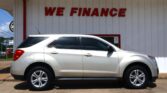 White SUV parked in front of a light-gray building with a bold red "WE FINANCE" sign above.