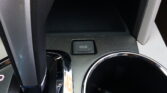Close-up of car center console showing an 'ECO' drive mode button.