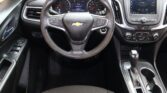 Steering wheel with Chevy logo, digital instrument cluster, and center infotainment screen in a SUV interior.