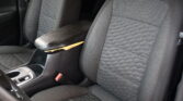Black car interior seats with quilted fabric and orange stitching, center console with cup holders nearby.