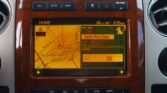 In-car navigation screen showing a map and the current radio station, Yacht Rock Radio, on the right.