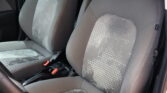Front car seats in gray fabric with a white dotted pattern, showing the seat backs and center area.