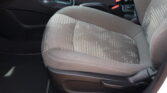 Front passenger seat in a car with gray patterned upholstery and a center console visible between seats