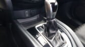 Close-up of a car center console with the gear shifter and USB/AUX ports panel nearby.