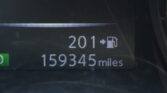 Car dashboard display showing the odometer reading 159,345 miles with a small green bar on the left and partial digits above it.