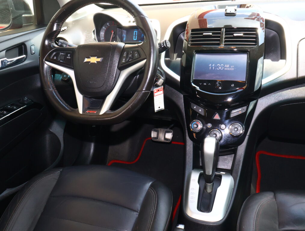 Driver's cockpit with leather-wrapped steering wheel, digital instrument cluster, and glossy center touchscreen in a Chevrolet interior