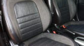 Black leather car seats with red contrast stitching and RS embroidery visible on headrests/leather panels.