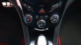 Center console of a car showing the hazard light button, lock controls, and climate control dials.