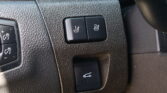 Two heated-seat buttons (1 and 2) on a textured car dashboard for front-seat heating