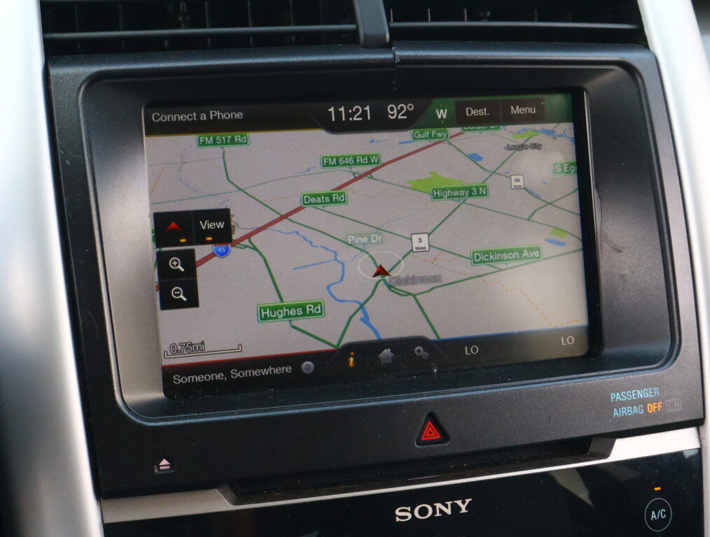 In-dash GPS map showing road names like FM 517 Rd, Hughes Rd, and Highway 3 N on a car's navigation screen