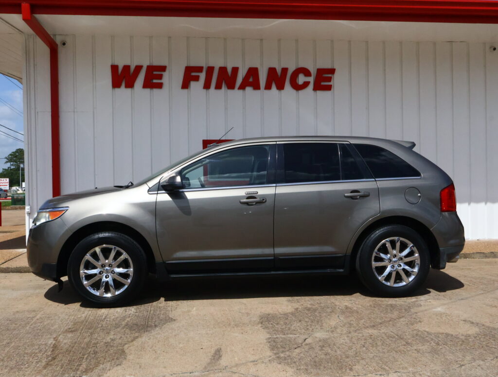 Silver SUV parked at a building with a white wall and a bold red 'WE FINANCE' sign above it.