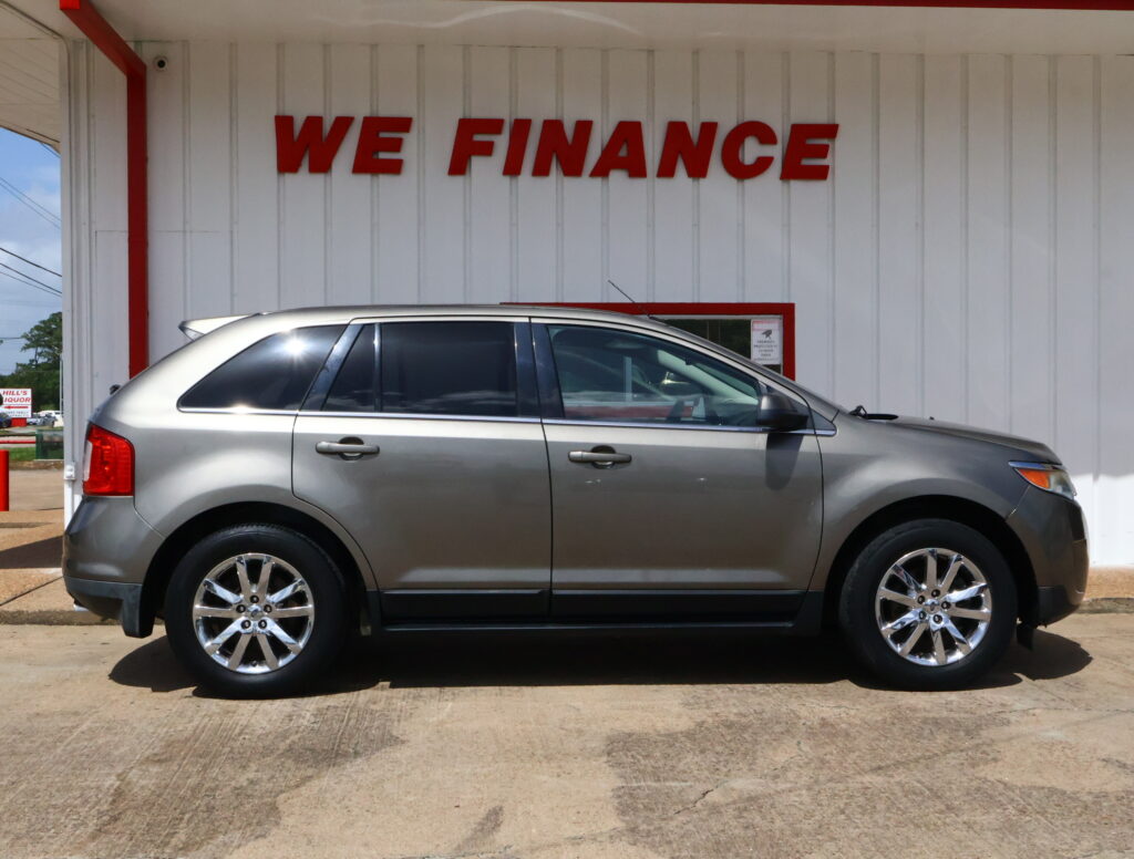 Silver SUV parked in front of a white wall with a red 'WE FINANCE' sign