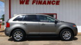 Silver SUV parked in front of a white wall with a red 'WE FINANCE' sign