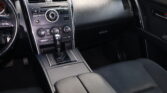 Interior of a car showing the center console with climate controls and gear shifter.