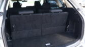 Open hatchback showing cargo area with two back rows upright in a dark interior.