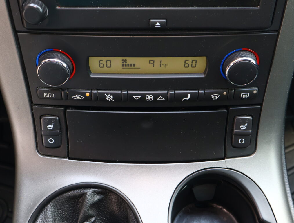 Center console climate control with dual temperature dials set to 60°, and a digital display showing 91°F in the middle.